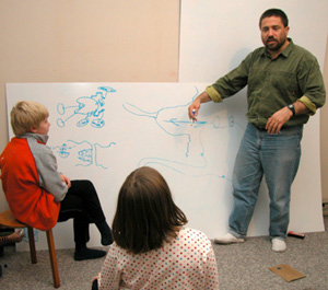 Coach Gray, Teddy, and Sarah working on research