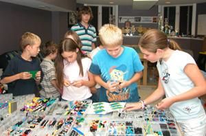 Luke, Megan, Teddy, and Amy building