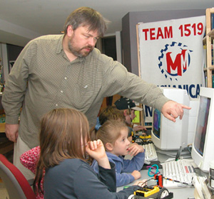 Coach Ericson instructing Sarah in the ways of RoboLab